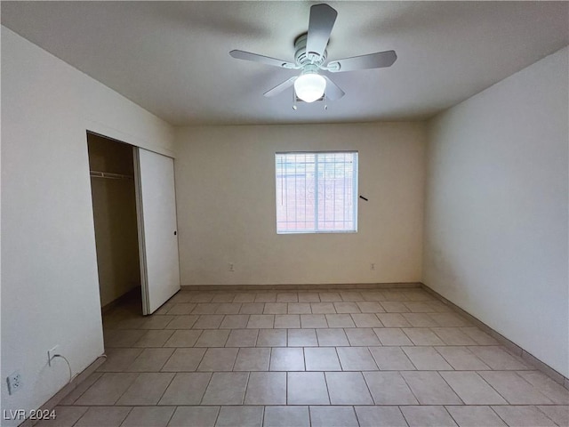 unfurnished bedroom featuring ceiling fan and a closet