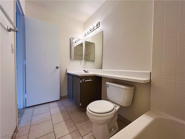 bathroom with tile patterned floors, toilet, a bath, and vanity