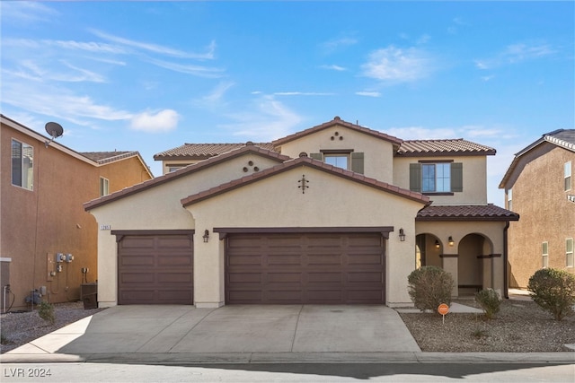 mediterranean / spanish home featuring a garage