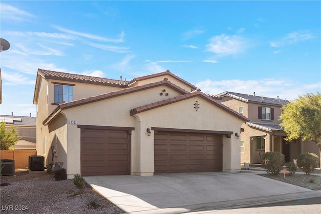 mediterranean / spanish-style house featuring central AC and a garage