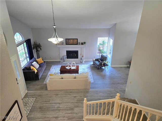 living room with hardwood / wood-style flooring and a tiled fireplace