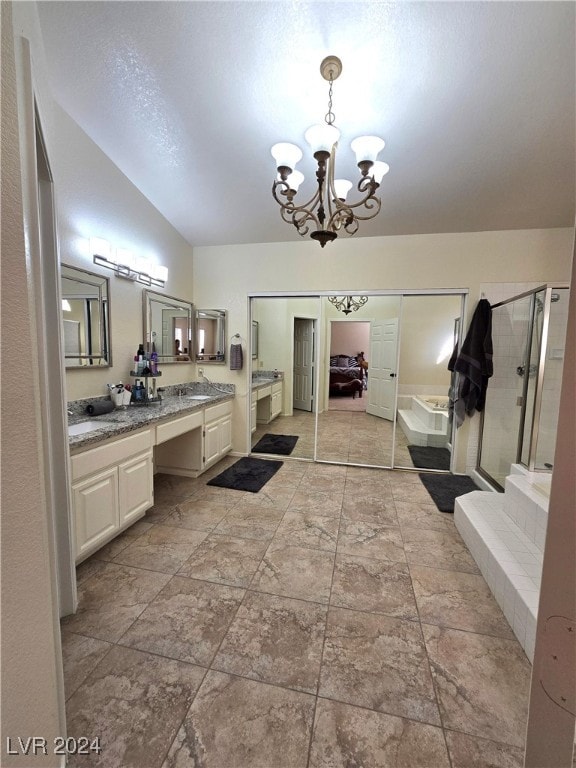 bathroom featuring separate shower and tub, vanity, vaulted ceiling, and a notable chandelier