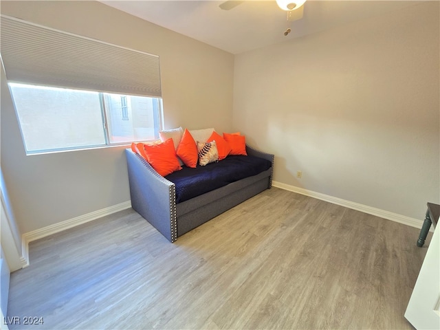 living area with ceiling fan and light wood-type flooring