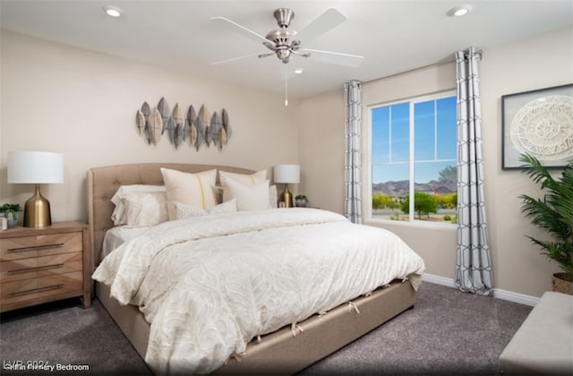 bedroom featuring ceiling fan and dark carpet