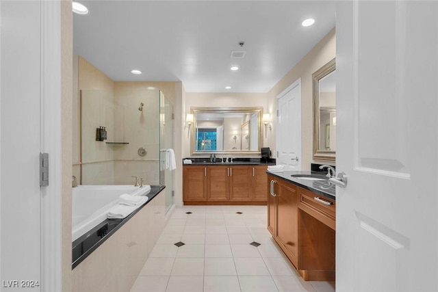 bathroom featuring tile patterned flooring, vanity, and shower with separate bathtub