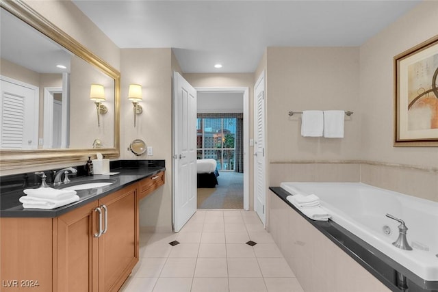 bathroom with tile patterned floors, vanity, and a bath