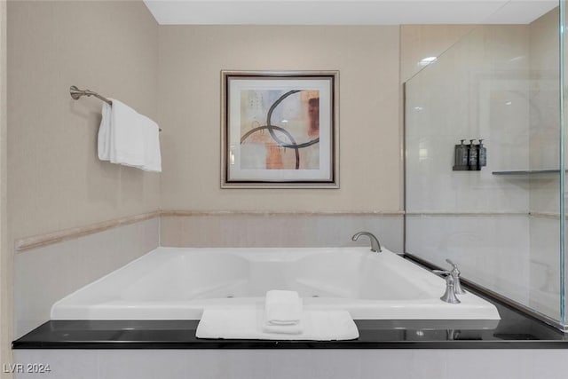 bathroom featuring tiled bath