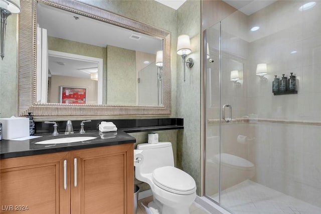 bathroom with tile patterned floors, toilet, vanity, and walk in shower