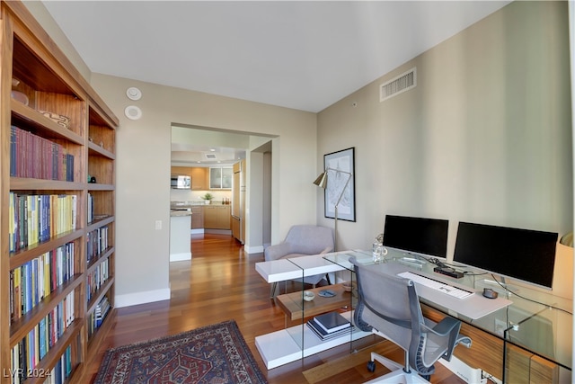 office with dark wood-type flooring