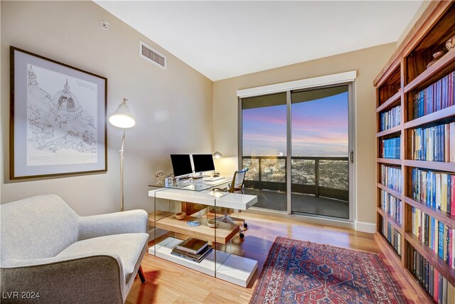 home office featuring hardwood / wood-style flooring and lofted ceiling