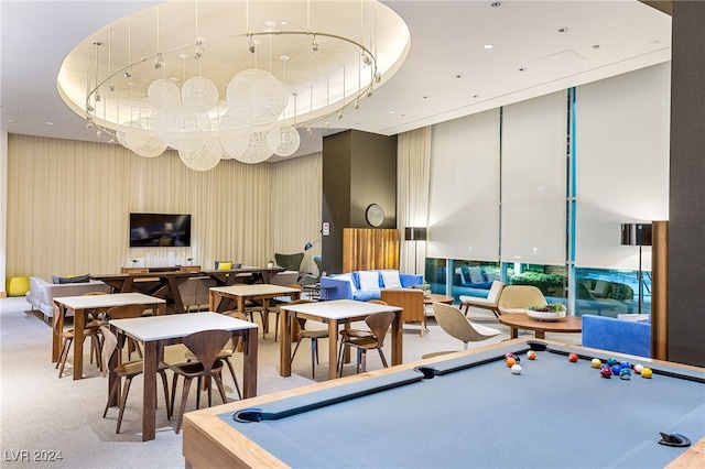 playroom with carpet, pool table, floor to ceiling windows, and a raised ceiling