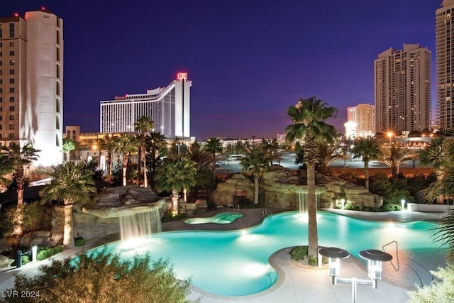 view of pool featuring a patio and a hot tub