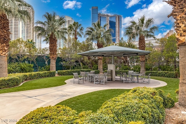 view of property's community with a lawn, a patio area, and a gazebo