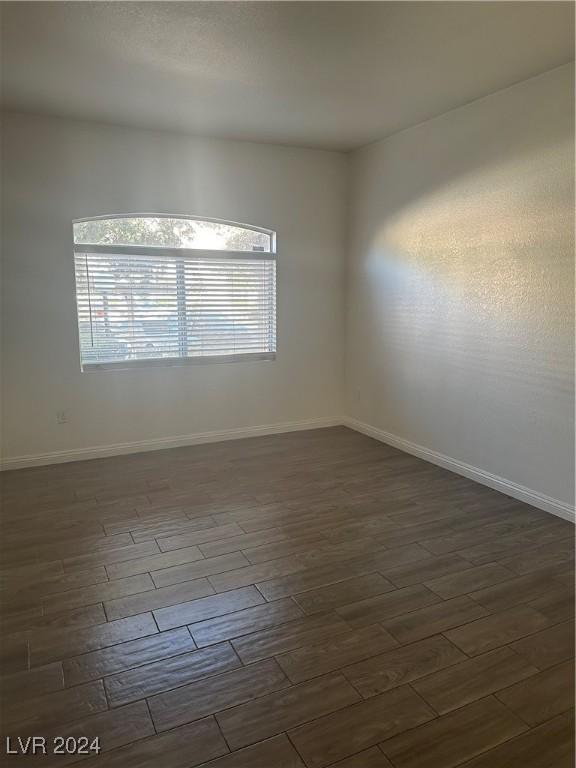 unfurnished room featuring dark hardwood / wood-style flooring