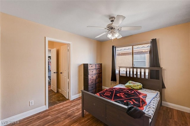 bedroom with a ceiling fan, baseboards, and wood finished floors