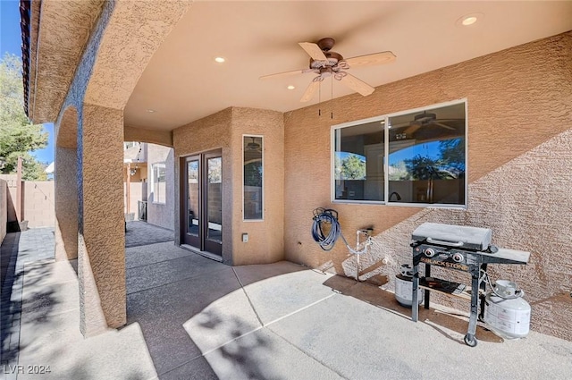 view of patio / terrace featuring area for grilling, fence, and a ceiling fan