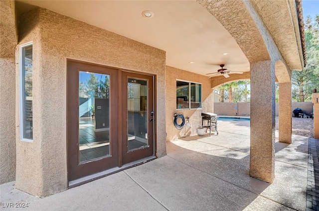 view of patio featuring a fenced in pool, fence, and ceiling fan