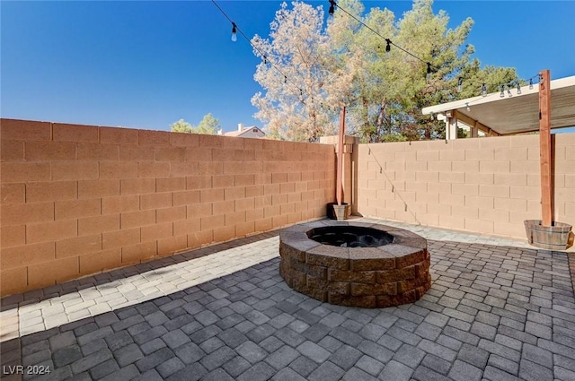 view of patio with a fenced backyard and a fire pit