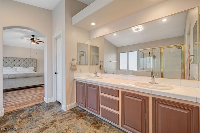 ensuite bathroom with double vanity, ensuite bath, a sink, and a shower stall