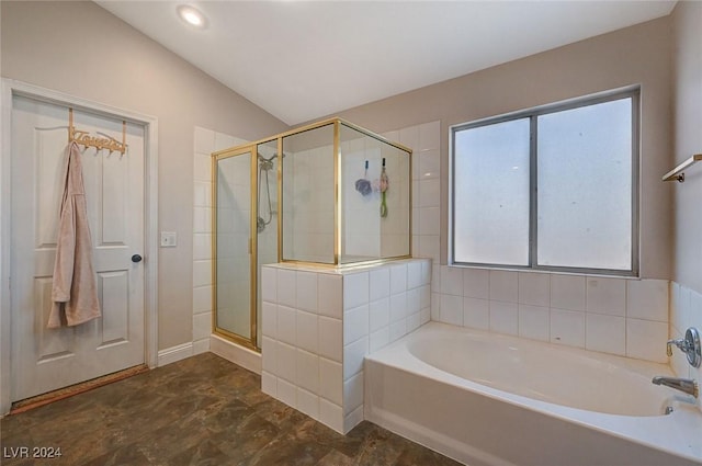 bathroom featuring a garden tub, a shower stall, and vaulted ceiling