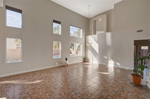 unfurnished living room with visible vents and baseboards