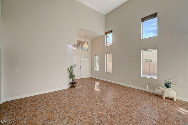 foyer entrance with a high ceiling and baseboards