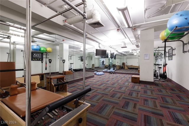 gym featuring dark colored carpet