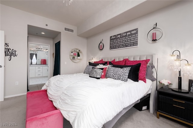 bedroom featuring carpet flooring, a chandelier, and ensuite bathroom