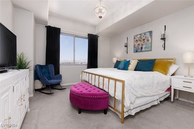 bedroom featuring light carpet and an inviting chandelier