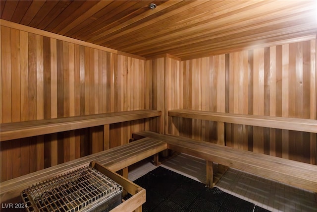 view of sauna / steam room featuring wooden ceiling and wood walls