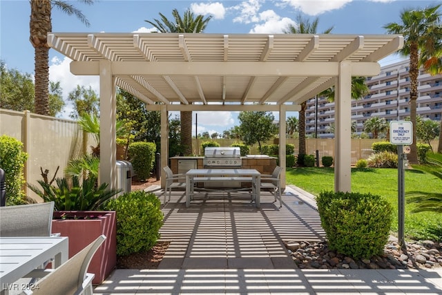 view of patio with a pergola and area for grilling