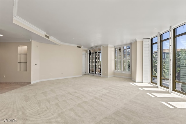 unfurnished living room featuring expansive windows, light colored carpet, and ornamental molding