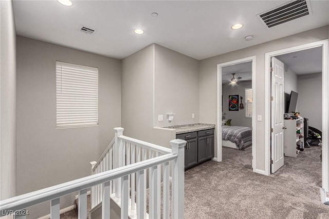 hallway with light colored carpet