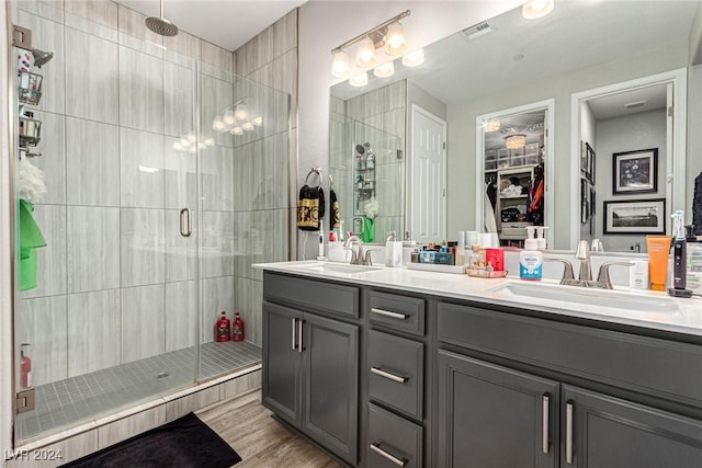 bathroom with a shower with door, vanity, and hardwood / wood-style flooring