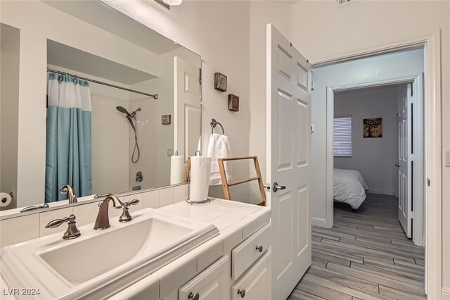 bathroom with hardwood / wood-style flooring and vanity