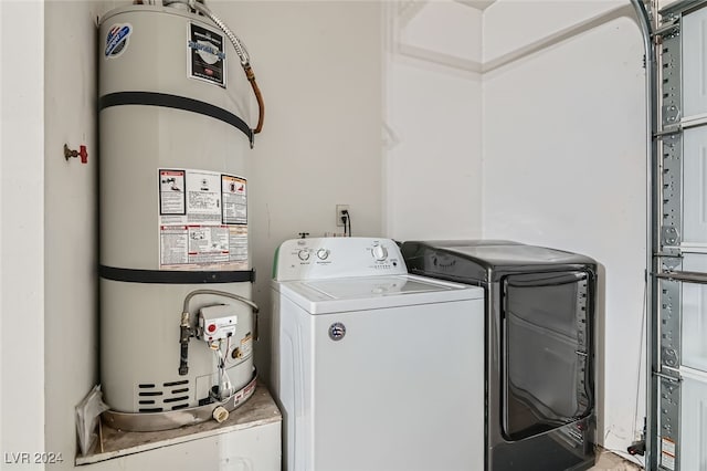 laundry area with washing machine and dryer and water heater