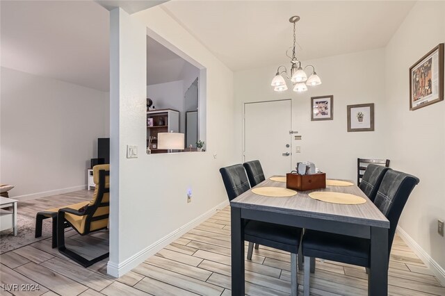 dining area featuring a notable chandelier and light hardwood / wood-style flooring