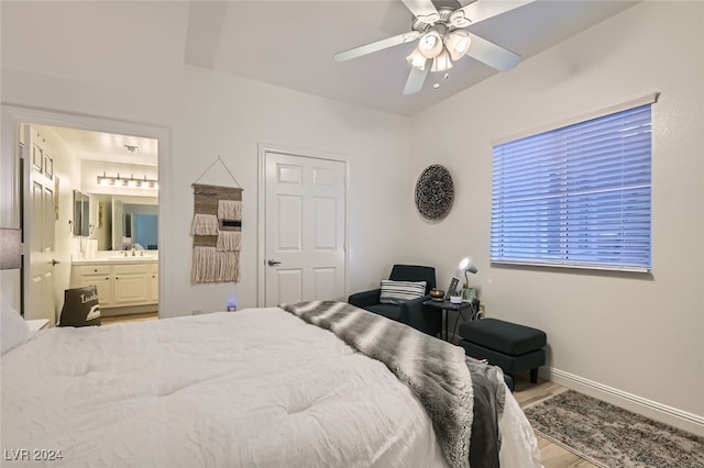 bedroom featuring ensuite bath, ceiling fan, sink, and light hardwood / wood-style floors