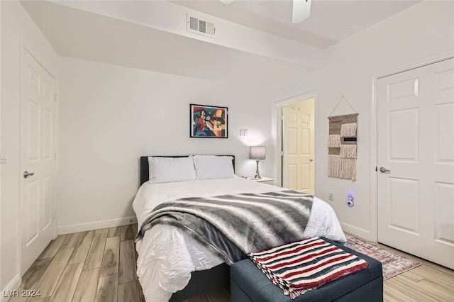 bedroom with ceiling fan and light hardwood / wood-style flooring