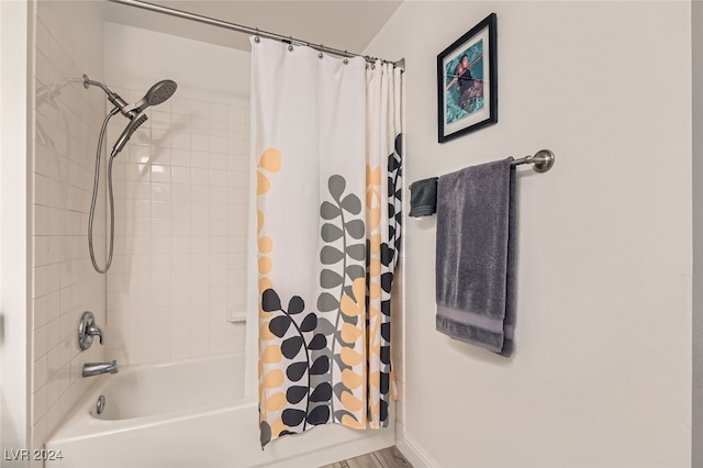 bathroom with shower / tub combo and hardwood / wood-style floors