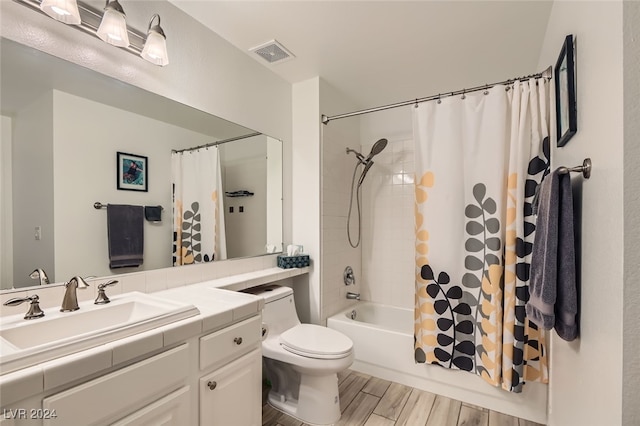 full bathroom featuring hardwood / wood-style floors, vanity, toilet, and shower / bathtub combination with curtain