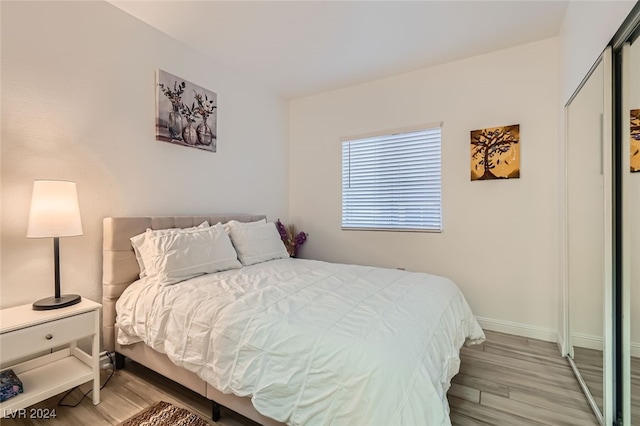 bedroom featuring a closet and light wood-type flooring