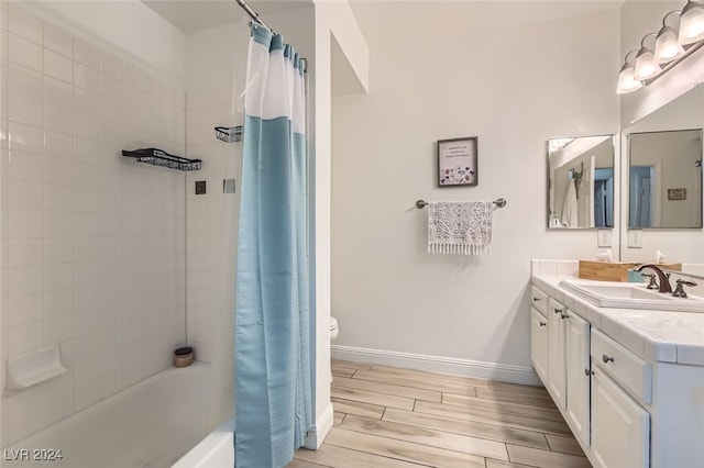 full bathroom with shower / tub combo, vanity, hardwood / wood-style flooring, and toilet