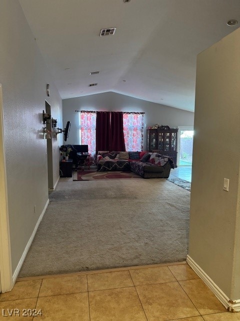 corridor featuring carpet flooring and vaulted ceiling