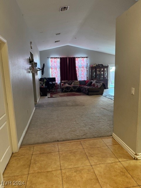 corridor with light colored carpet and lofted ceiling