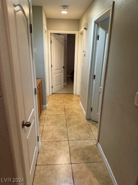 hallway featuring light tile patterned floors