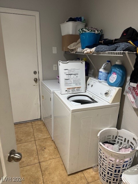 washroom featuring washing machine and dryer and light tile patterned flooring