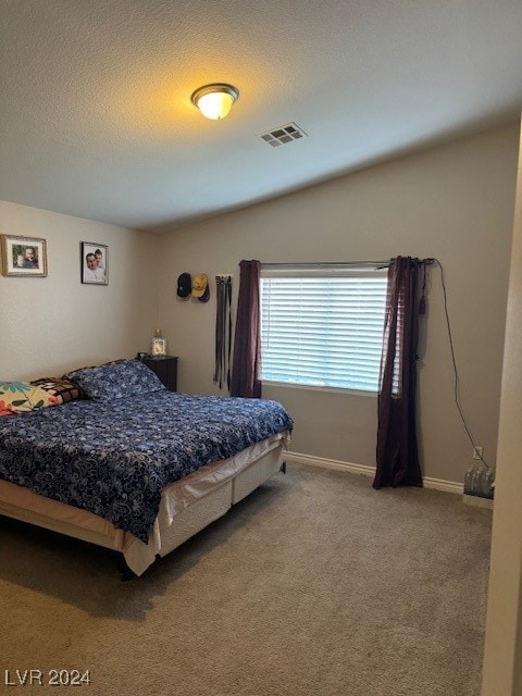 carpeted bedroom featuring a textured ceiling