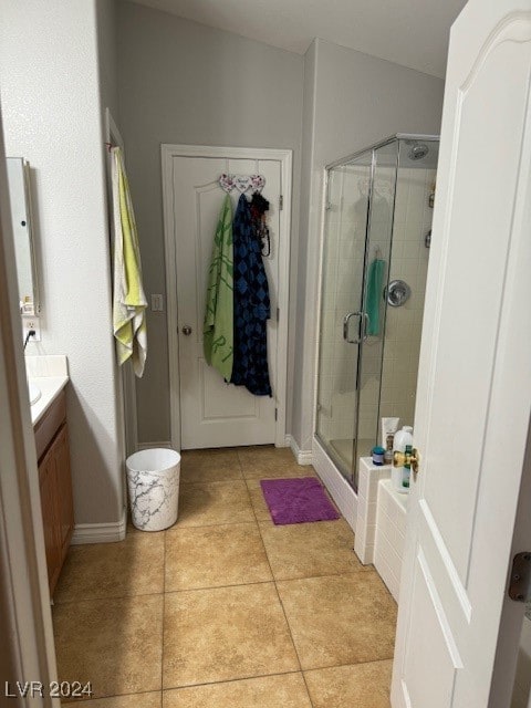 bathroom featuring tile patterned flooring, vanity, and walk in shower