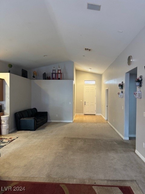 interior space with lofted ceiling and light carpet